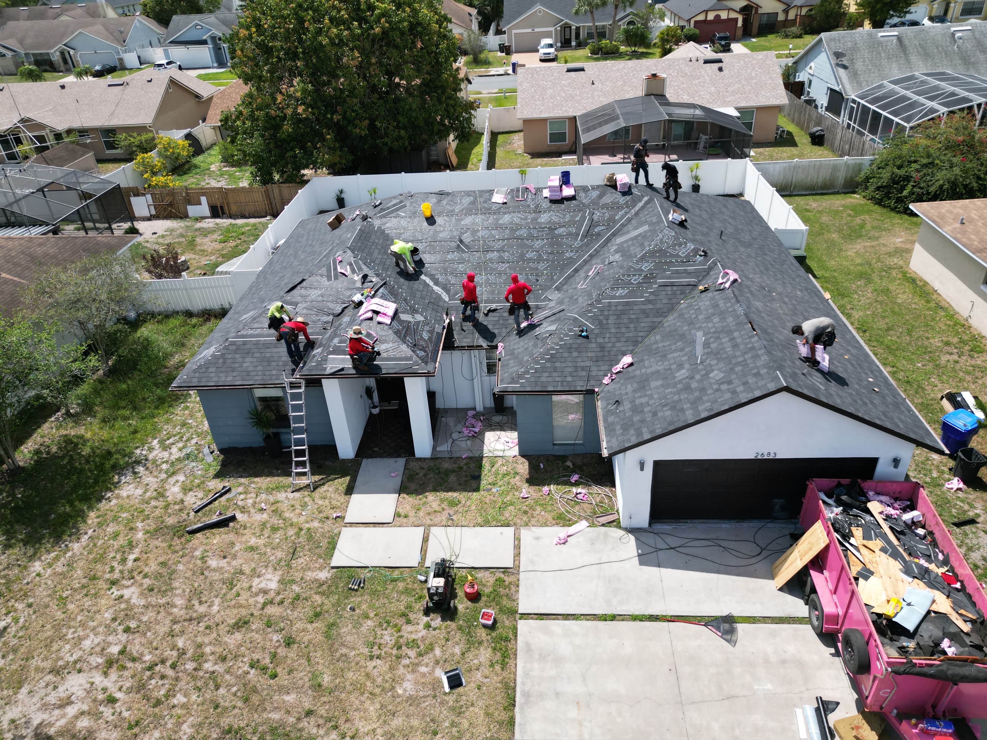 Midas Roofing crew working on a residential roof replacement